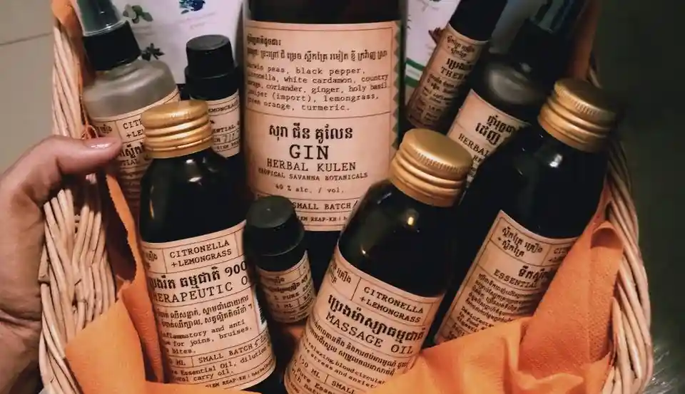 Basket of Herbal Kulen gin, lemongrass massage oil, essential oils and other Cambodian botanical products.