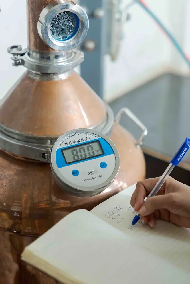Distillation temperature being recorded beside the copper still during Herbal Kulen gin production.