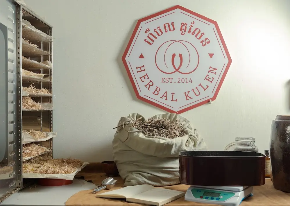 Herbal Kulen herbs room with dried botanicals, weighing equipment and the distillery logo.