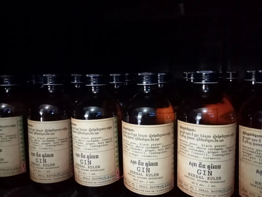 Rows of small-batch Herbal Kulen gin bottles made with Cambodian botanicals.