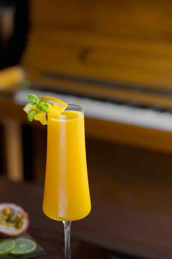 Tropical Passion Kulen cocktail with passion fruit, citrus and a fresh mint garnish.