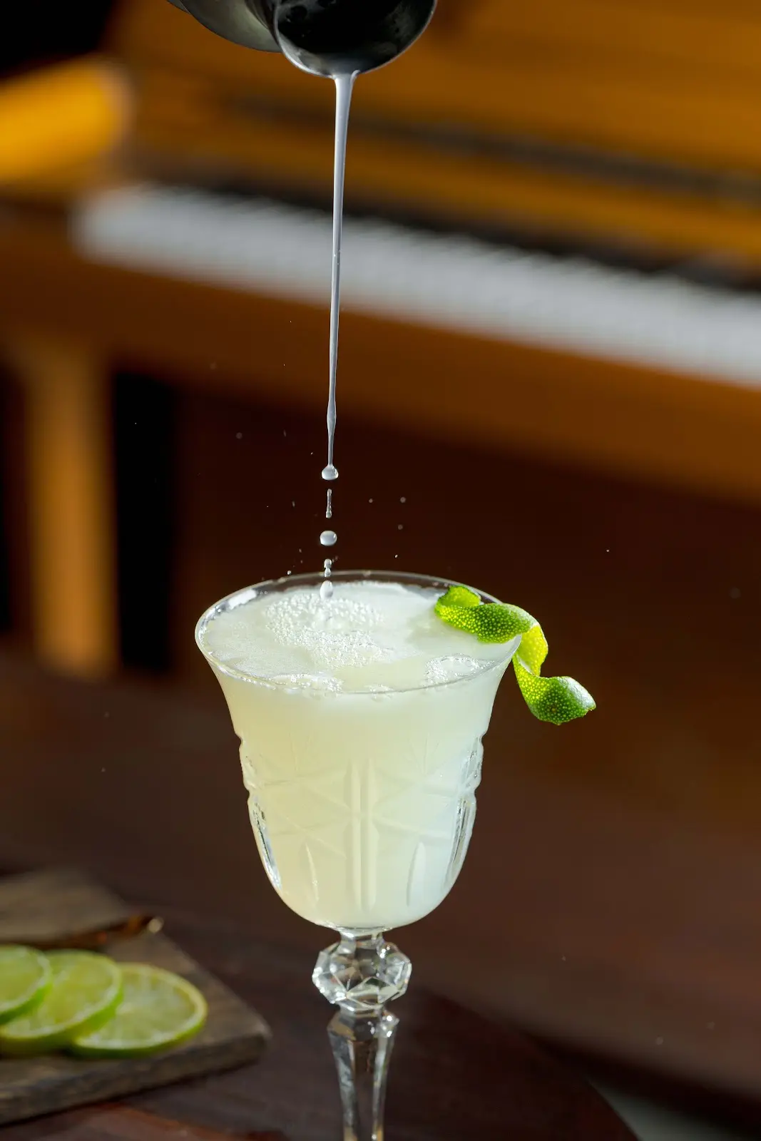 Foamy White Lady cocktail made with Herbal Kulen gin and finished with a lime peel.